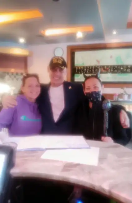 Meeting with buffet staff, author David Haave promotes fundraiser for local food pantry.